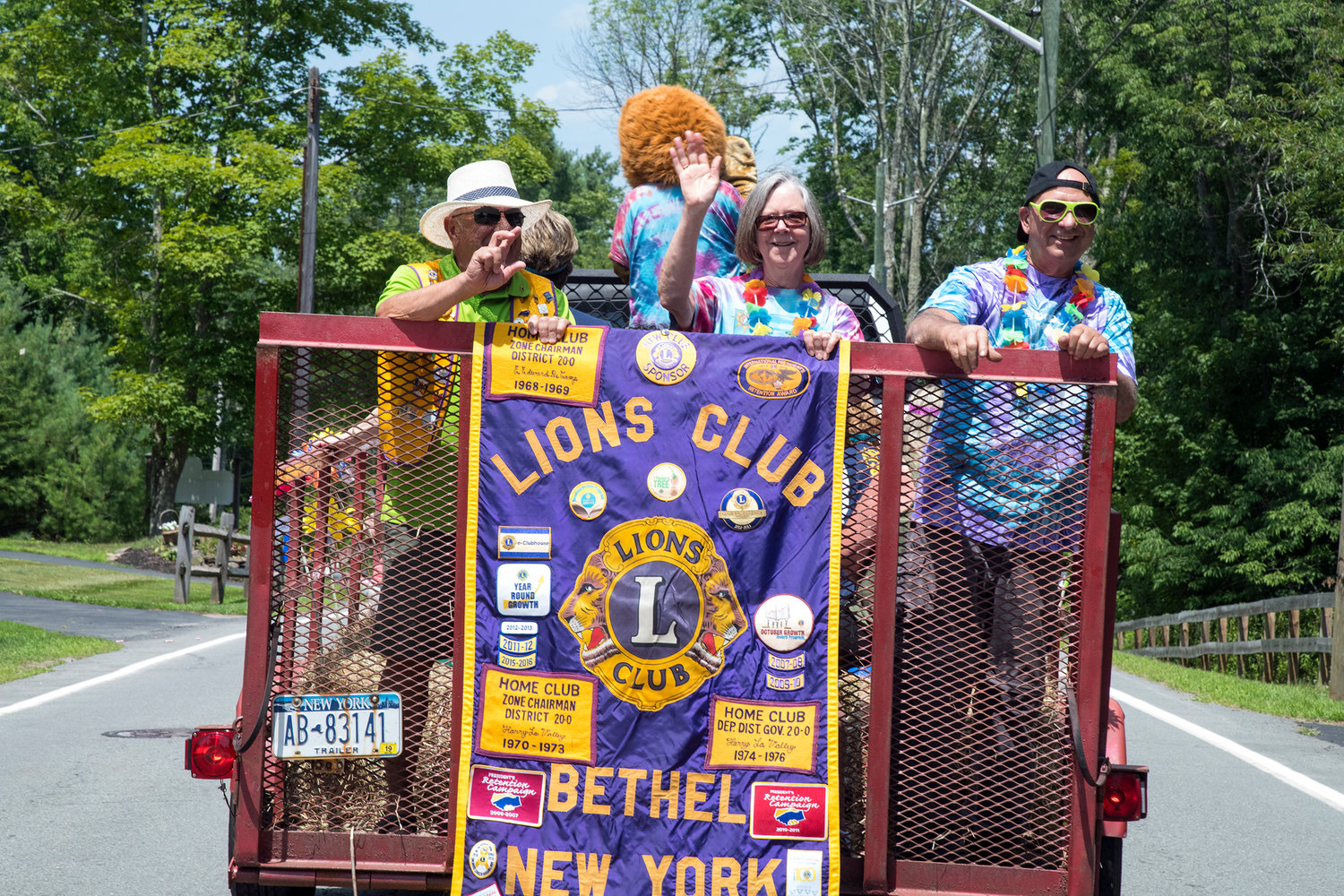 Bethel Lions, (L-R) John Bogaert, Marie Fox, and Mike Fox serve up some good cheer to the crowd.